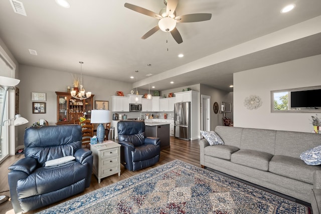1473 W Jay Ct, Spokane, WA 99208 - living room featuring dark wood-type flooring, a ceiling fan, a chandelier, and recessed lighting