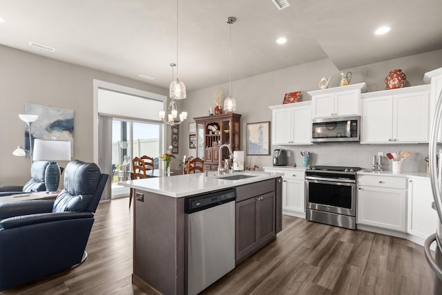 1473 W Jay Ct, Spokane, WA 99208 - kitchen featuring stainless steel appliances, a sink, open floor plan, light countertops, and a chandelier