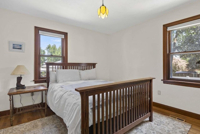 967 E 13th Ave, Spokane, WA 99202 - bedroom featuring multiple windows, wood finished floors, and baseboards