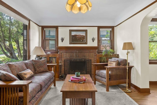 967 E 13th Ave, Spokane, WA 99202 - living room with arched walkways, wood finished floors, a fireplace, and baseboards