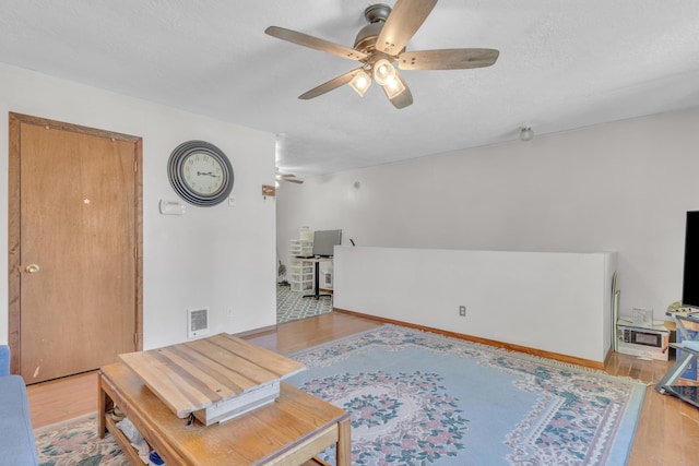 3228 E 29th Ave, Spokane, WA 99223 - living area featuring a ceiling fan, wood finished floors, and a textured ceiling