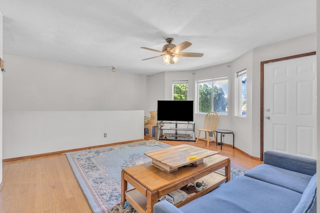 3228 E 29th Ave, Spokane, WA 99223 - living room featuring ceiling fan, baseboards, light wood-style flooring, and a textured ceiling