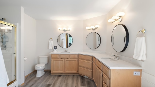 6314 W Skagit Ave, Spokane, WA 99208 - bathroom featuring wood finished floors, double vanity, and a shower stall