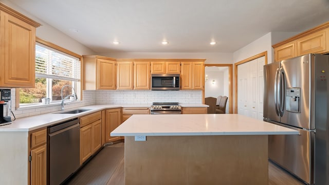 6314 W Skagit Ave, Spokane, WA 99208 - kitchen with stainless steel appliances, a sink, a center island, light brown cabinets, and recessed lighting
