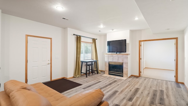 6314 W Skagit Ave, Spokane, WA 99208 - living room with light wood-type flooring, a fireplace, baseboards, and recessed lighting