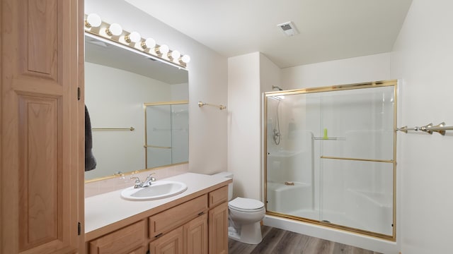 6314 W Skagit Ave, Spokane, WA 99208 - bathroom featuring a shower stall, vanity, toilet, and wood finished floors