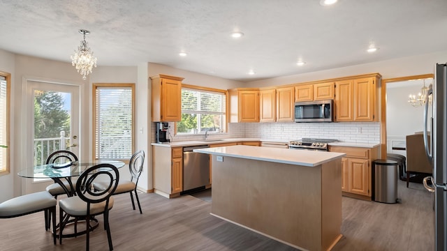 6314 W Skagit Ave, Spokane, WA 99208 - kitchen with appliances with stainless steel finishes, a chandelier, light wood-type flooring, and recessed lighting