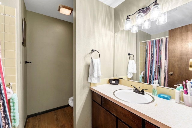 4405 E 46th Ave, Spokane, WA 99223 - bathroom with vanity, toilet, wood finished floors, and a shower with shower curtain