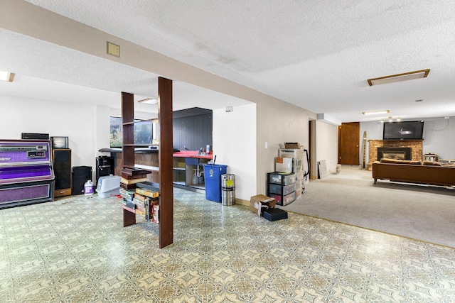 4405 E 46th Ave, Spokane, WA 99223 - finished basement featuring a textured ceiling, a fireplace, baseboards, and carpet