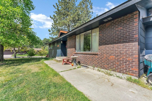 4405 E 46th Ave, Spokane, WA 99223 - doorway to property featuring brick siding and a lawn