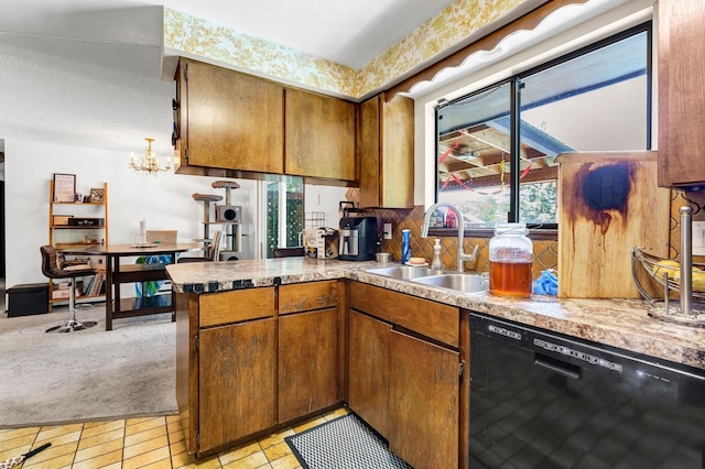 4405 E 46th Ave, Spokane, WA 99223 - kitchen with dishwasher, a sink, brown cabinets, and a chandelier