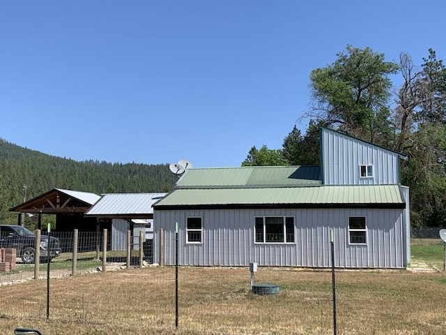 2694B Sand Canyon Rd, Chewelah, WA 99109 - rear view of property featuring board and batten siding and a forest view