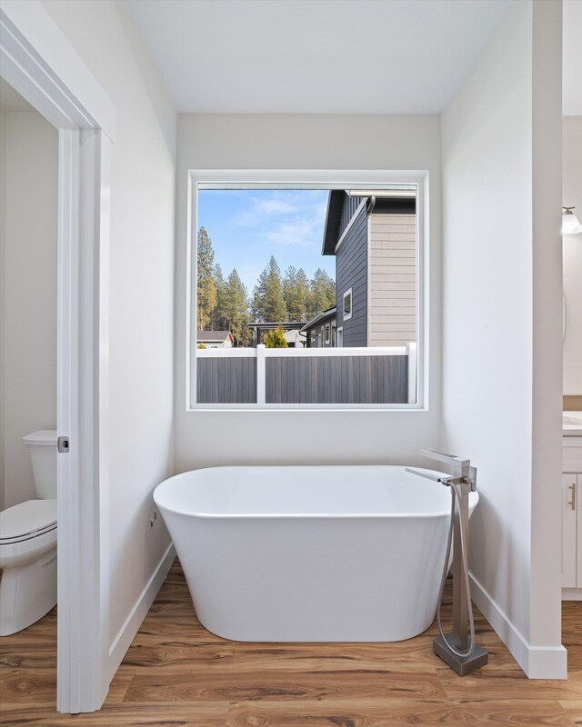 3405 E Yearling Rd, Chattaroy, WA 99003 - bathroom with baseboards, wood finished floors, and a freestanding tub