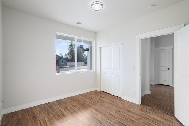 3405 E Yearling Rd, Chattaroy, WA 99003 - unfurnished bedroom with wood finished floors, baseboards, and a closet