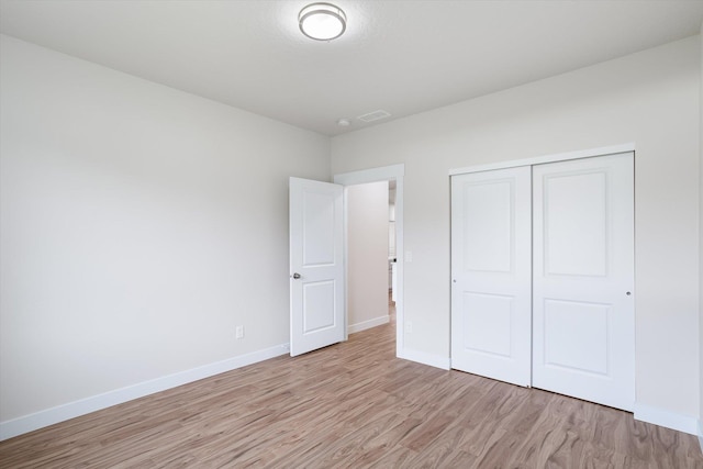 3405 E Yearling Rd, Chattaroy, WA 99003 - unfurnished bedroom with light wood-style floors, baseboards, and a closet