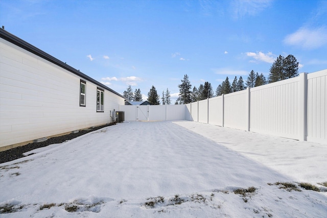 3405 E Yearling Rd, Chattaroy, WA 99003 - yard layered in snow featuring a fenced backyard, a gate, and central AC unit