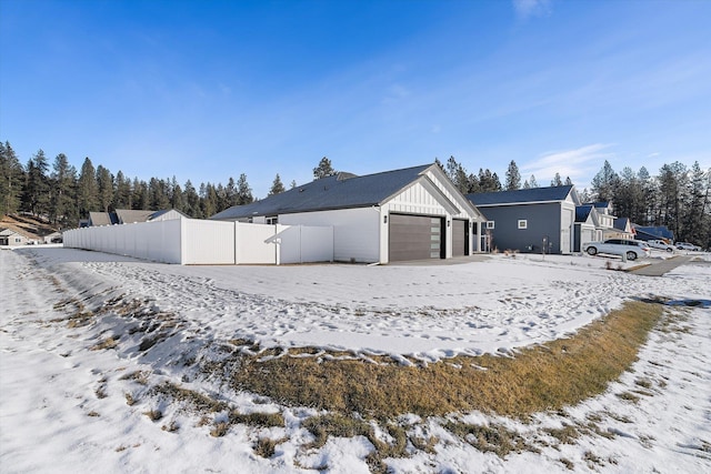 3405 E Yearling Rd, Chattaroy, WA 99003 - view of snow covered exterior featuring board and batten siding