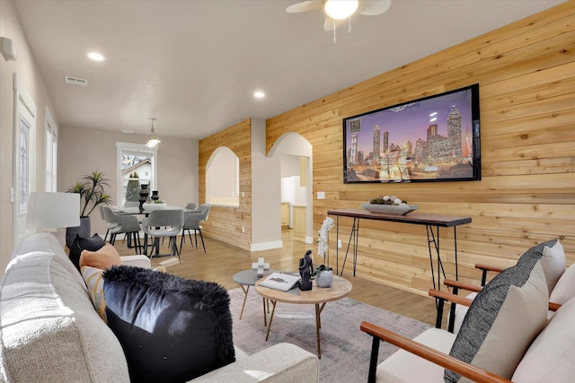 524 N Long Rd, Spokane Valley, WA 99016 - living room featuring wood walls, arched walkways, recessed lighting, ceiling fan, and wood finished floors