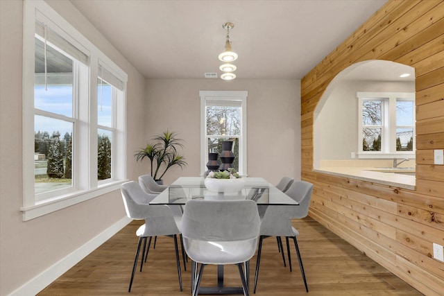 524 N Long Rd, Spokane Valley, WA 99016 - dining area with wooden walls, wood finished floors, baseboards, and arched walkways