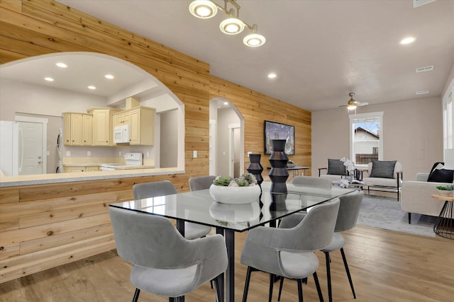 524 N Long Rd, Spokane Valley, WA 99016 - dining space with wood walls, arched walkways, recessed lighting, light wood-style flooring, and a ceiling fan