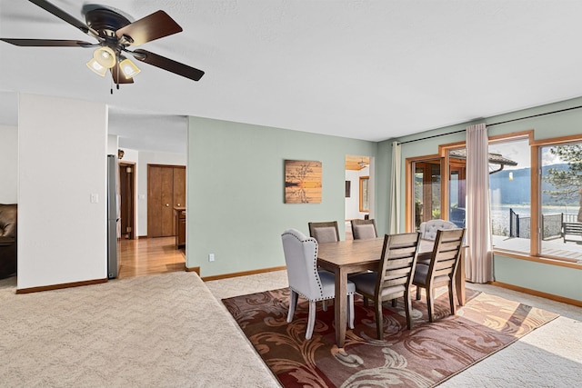 2378 Eagle River Way, Kettle Falls, WA 99141 - dining space with light colored carpet, baseboards, and a ceiling fan