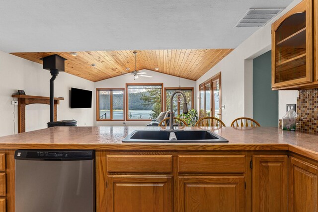 2378 Eagle River Way, Kettle Falls, WA 99141 - kitchen with stainless steel dishwasher, a sink, vaulted ceiling, glass insert cabinets, and brown cabinets