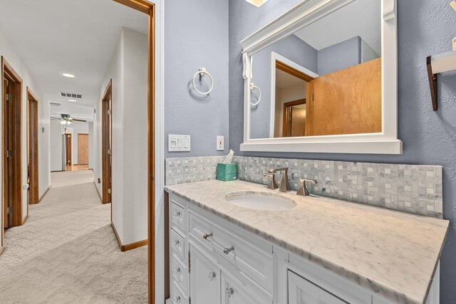 2378 Eagle River Way, Kettle Falls, WA 99141 - bathroom featuring vanity, backsplash, baseboards, and ceiling fan