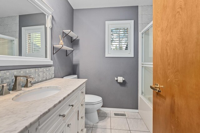 2378 Eagle River Way, Kettle Falls, WA 99141 - full bath featuring toilet, vanity, baseboards, tile patterned flooring, and shower / bath combination with glass door