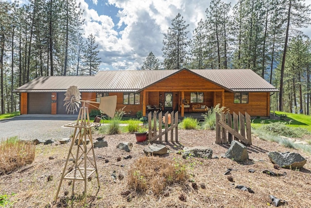 2378 Eagle River Way, Kettle Falls, WA 99141 - chalet / cabin featuring a porch, metal roof, and gravel driveway