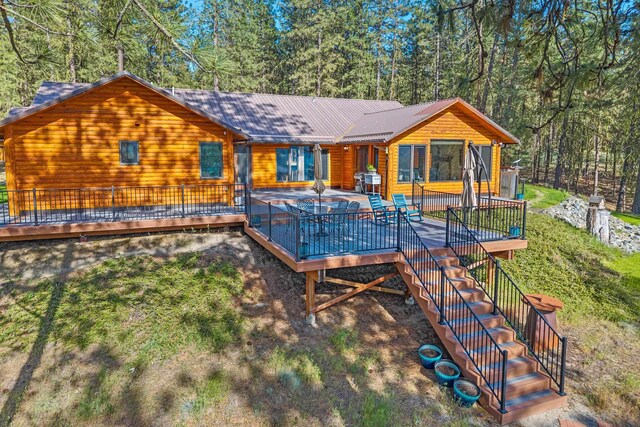 2378 Eagle River Way, Kettle Falls, WA 99141 - back of property featuring a wooden deck, stairway, and metal roof