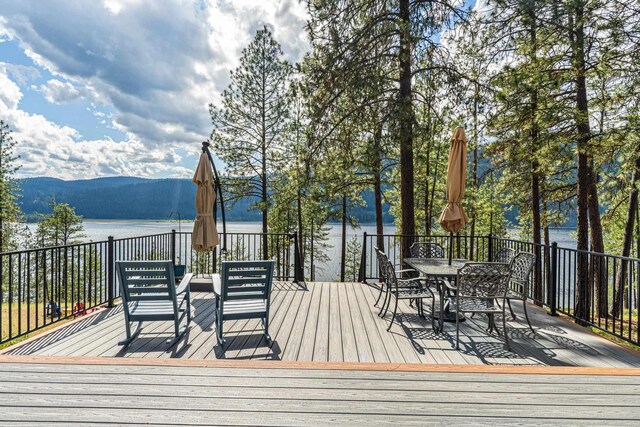 2378 Eagle River Way, Kettle Falls, WA 99141 - wooden terrace featuring a water and mountain view and outdoor dining space