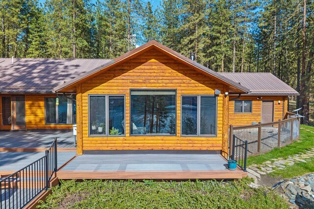 2378 Eagle River Way, Kettle Falls, WA 99141 - back of house with log veneer siding, metal roof, and a wooden deck