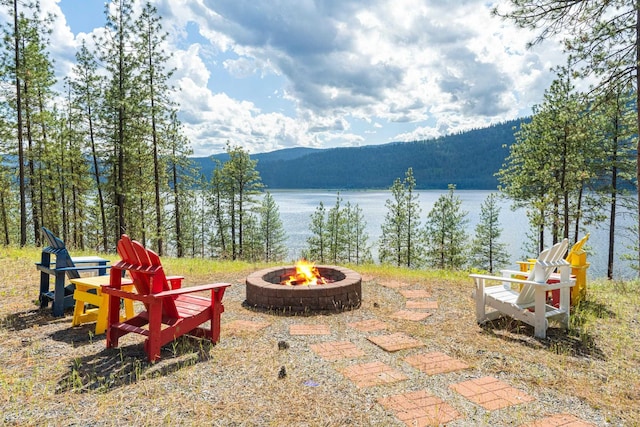 2378 Eagle River Way, Kettle Falls, WA 99141 - view of patio featuring an outdoor fire pit, a water and mountain view, and a view of trees