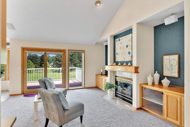 4605 E Birkdale Ln, Spokane, WA 99223 - living room with light carpet, a tiled fireplace, baseboards, and vaulted ceiling