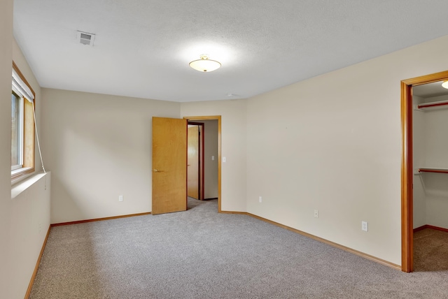 4605 E Birkdale Ln, Spokane, WA 99223 - unfurnished bedroom with a walk in closet, carpet flooring, baseboards, and a closet