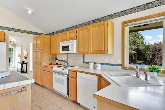 4605 E Birkdale Ln, Spokane, WA 99223 - kitchen featuring white appliances, vaulted ceiling, a sink, light tile patterned flooring, and light brown cabinets
