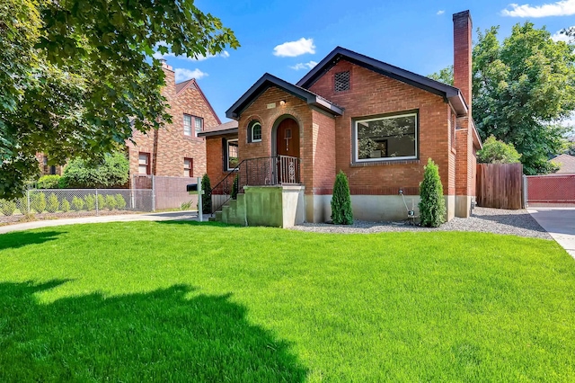 411 W 26th Ave, Spokane, WA 99203 - view of front of house featuring brick siding and a chimney