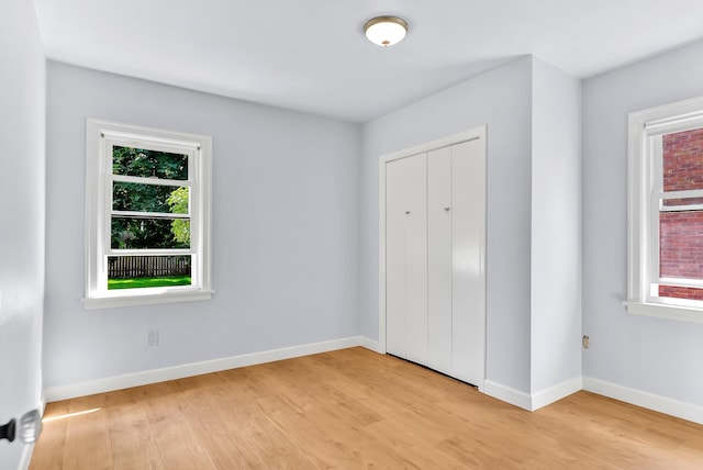 411 W 26th Ave, Spokane, WA 99203 - unfurnished bedroom featuring light wood finished floors, baseboards, and a closet