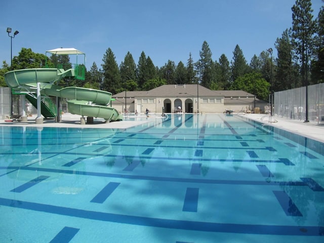 411 W 26th Ave, Spokane, WA 99203 - community pool with a water slide and view of scattered trees