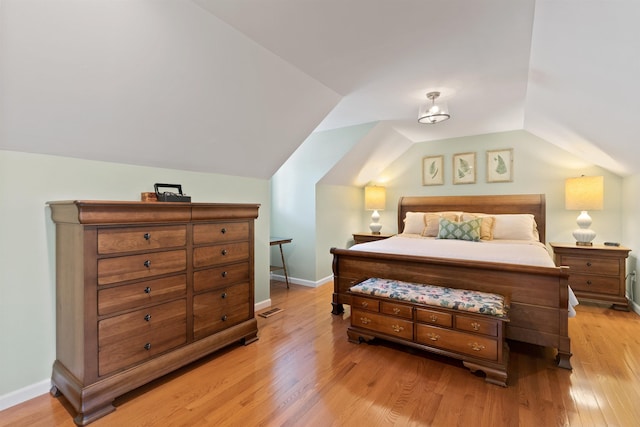 11605 N Merlin Dr, Spokane, WA 99218 - bedroom with vaulted ceiling, light wood-type flooring, and baseboards