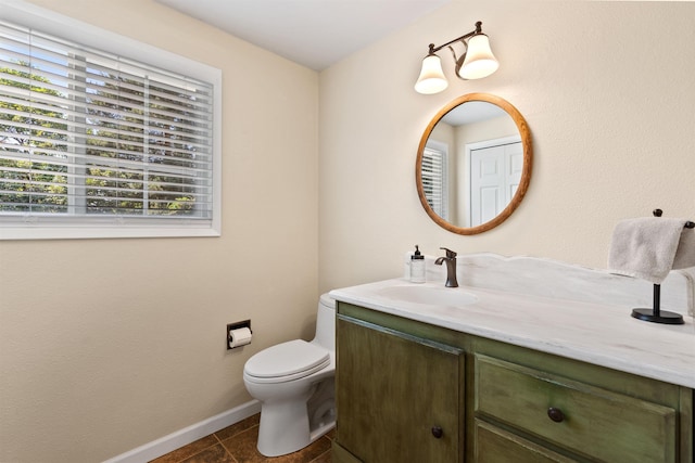 11605 N Merlin Dr, Spokane, WA 99218 - bathroom with vanity, toilet, baseboards, and tile patterned flooring