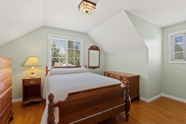 11605 N Merlin Dr, Spokane, WA 99218 - bedroom featuring light wood-style flooring, lofted ceiling, and baseboards