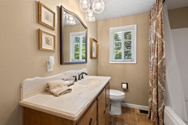 11605 N Merlin Dr, Spokane, WA 99218 - bathroom featuring vanity, plenty of natural light, toilet, and tile patterned flooring