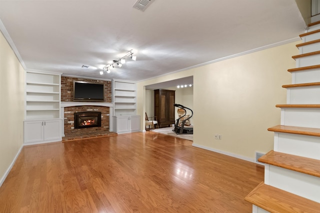 11605 N Merlin Dr, Spokane, WA 99218 - unfurnished living room featuring baseboards, a fireplace, and wood finished floors