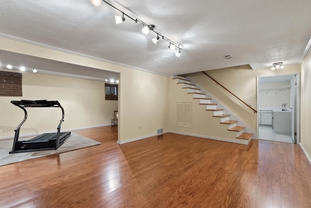 11605 N Merlin Dr, Spokane, WA 99218 - finished below grade area with stairway, wood finished floors, and baseboards