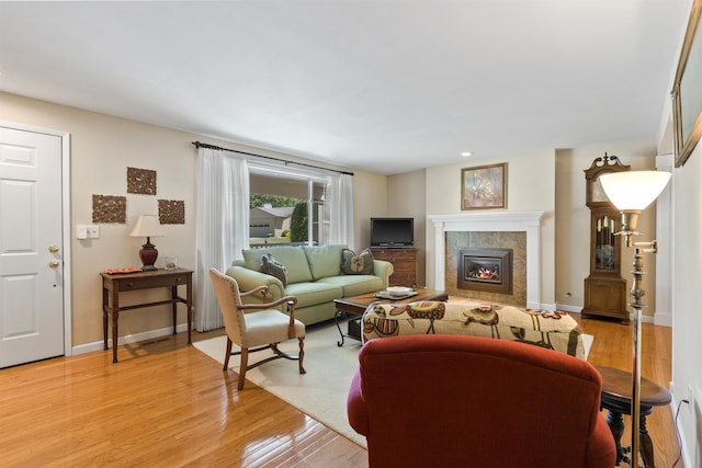 11605 N Merlin Dr, Spokane, WA 99218 - living area with light wood-style flooring, a tile fireplace, baseboards, and recessed lighting