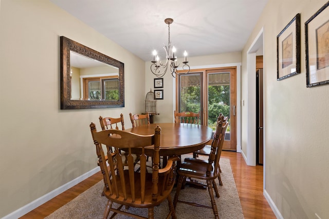 11605 N Merlin Dr, Spokane, WA 99218 - dining space featuring a chandelier, light wood-type flooring, and baseboards