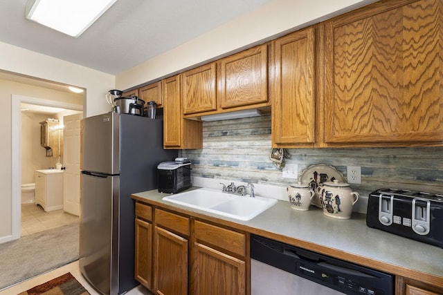 202 E Weile Ave Unit 2, Spokane, WA 99208 - kitchen with appliances with stainless steel finishes, a sink, light tile patterned flooring, and brown cabinets
