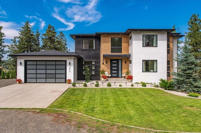 9610 S Mullen Hill Rd, Spokane, WA 99224 - contemporary house featuring concrete driveway, a garage, a front lawn, and stucco siding