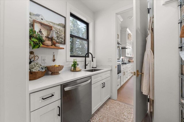 9610 S Mullen Hill Rd, Spokane, WA 99224 - kitchen with stainless steel dishwasher, a sink, and white cabinetry